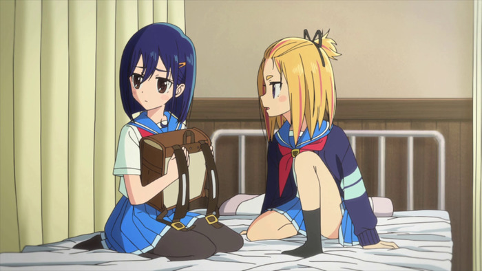 Yayaka and Cocona sit on a bed in the nurse's office